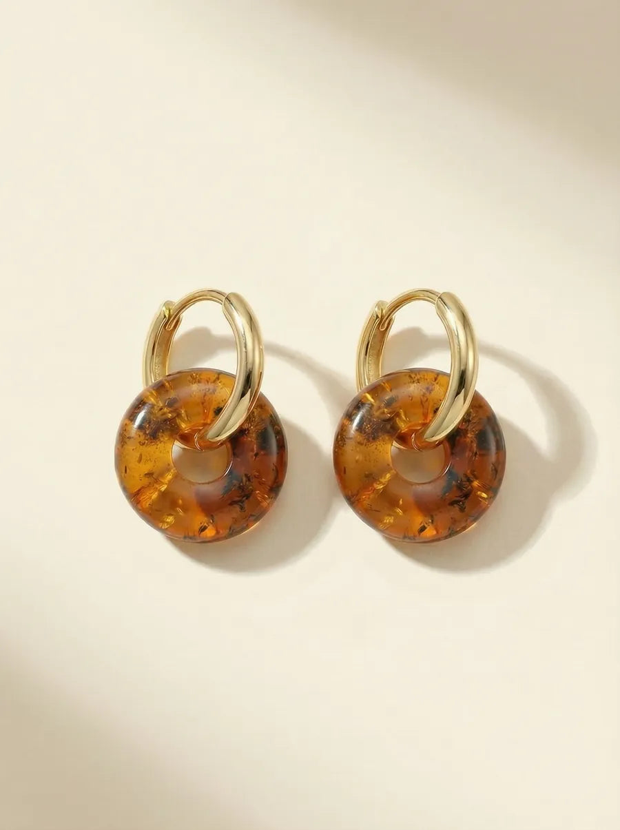 Pair of gold huggie hoop earrings with round amber beads