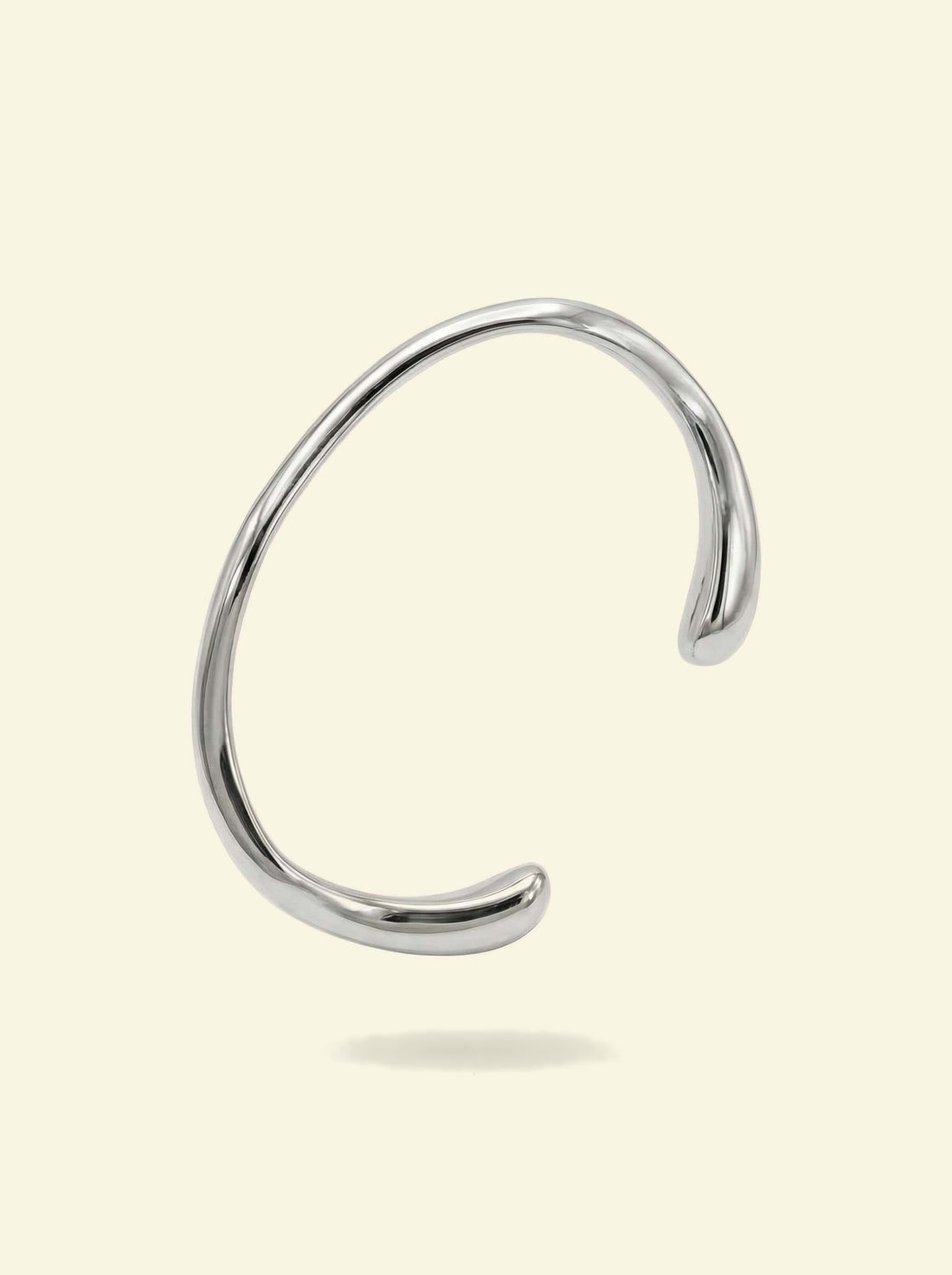 Arc Cuff, silver-tone open cuff with smooth rounded tips, angled view