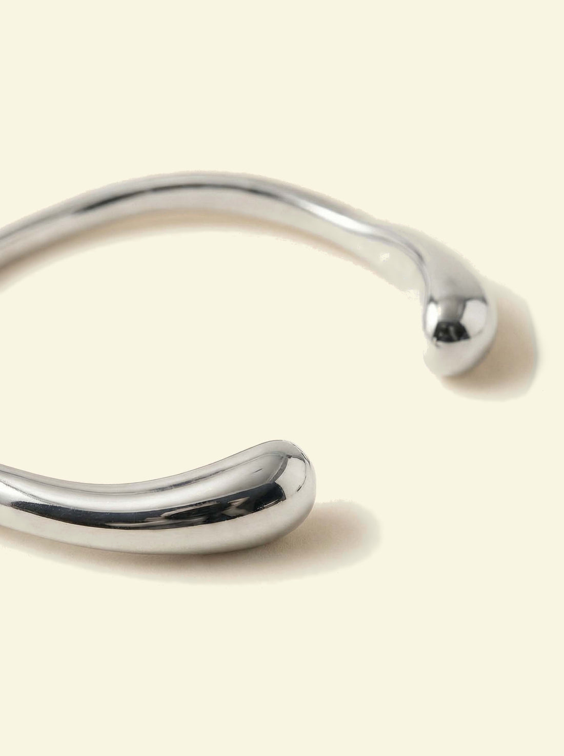 Arc Cuff, close-up of the silver-tone cuff's two rounded tips