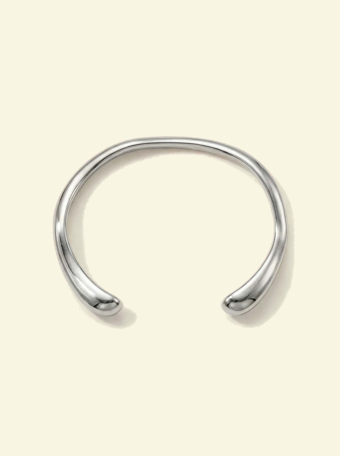 Arc Cuff, silver-tone open cuff with a wavy band and rounded tips, front view
