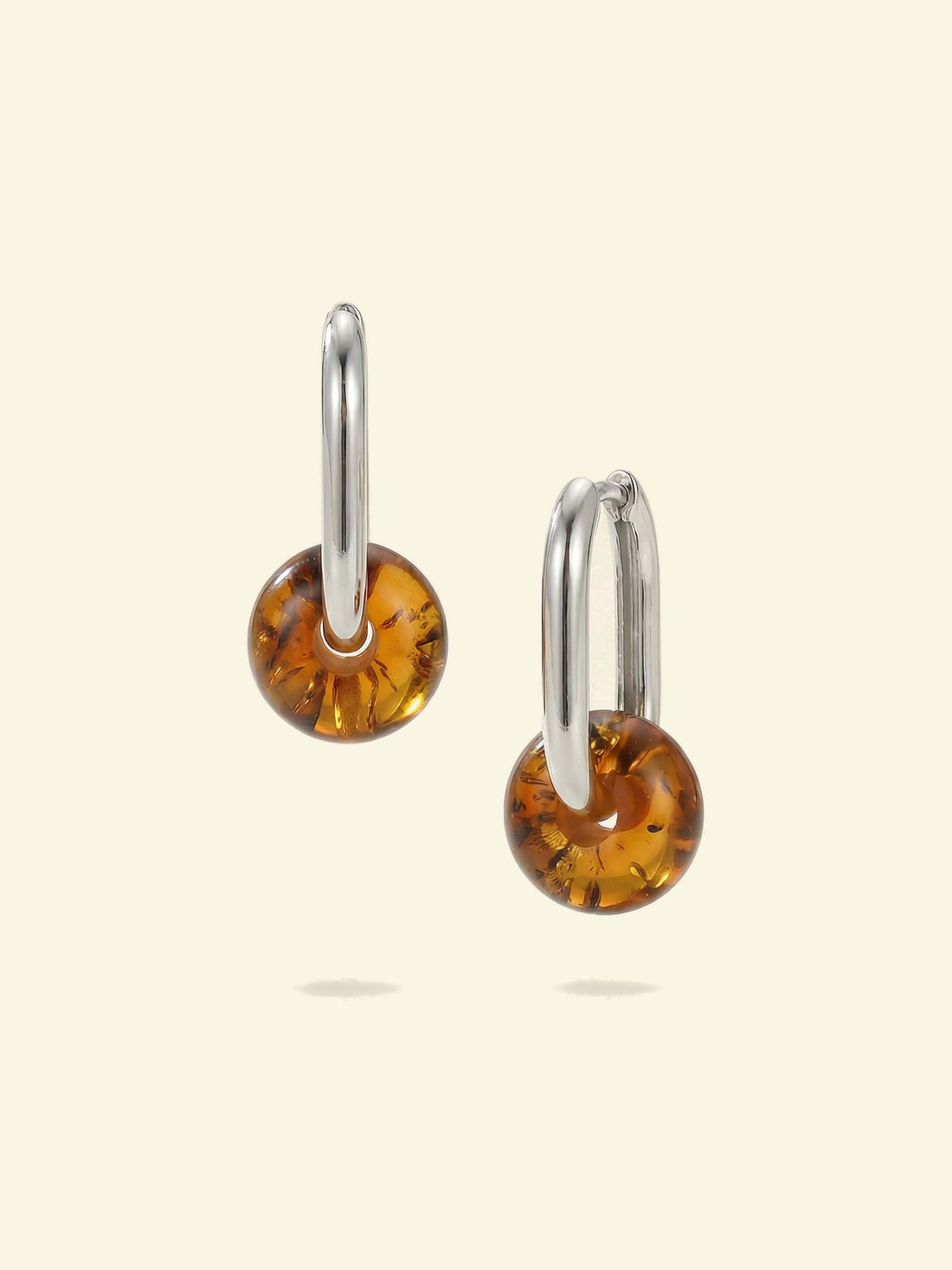 Dune Amber Hoops, pair of silver-tone hoops with amber-coloured beads, one shown side-on and one at an angle