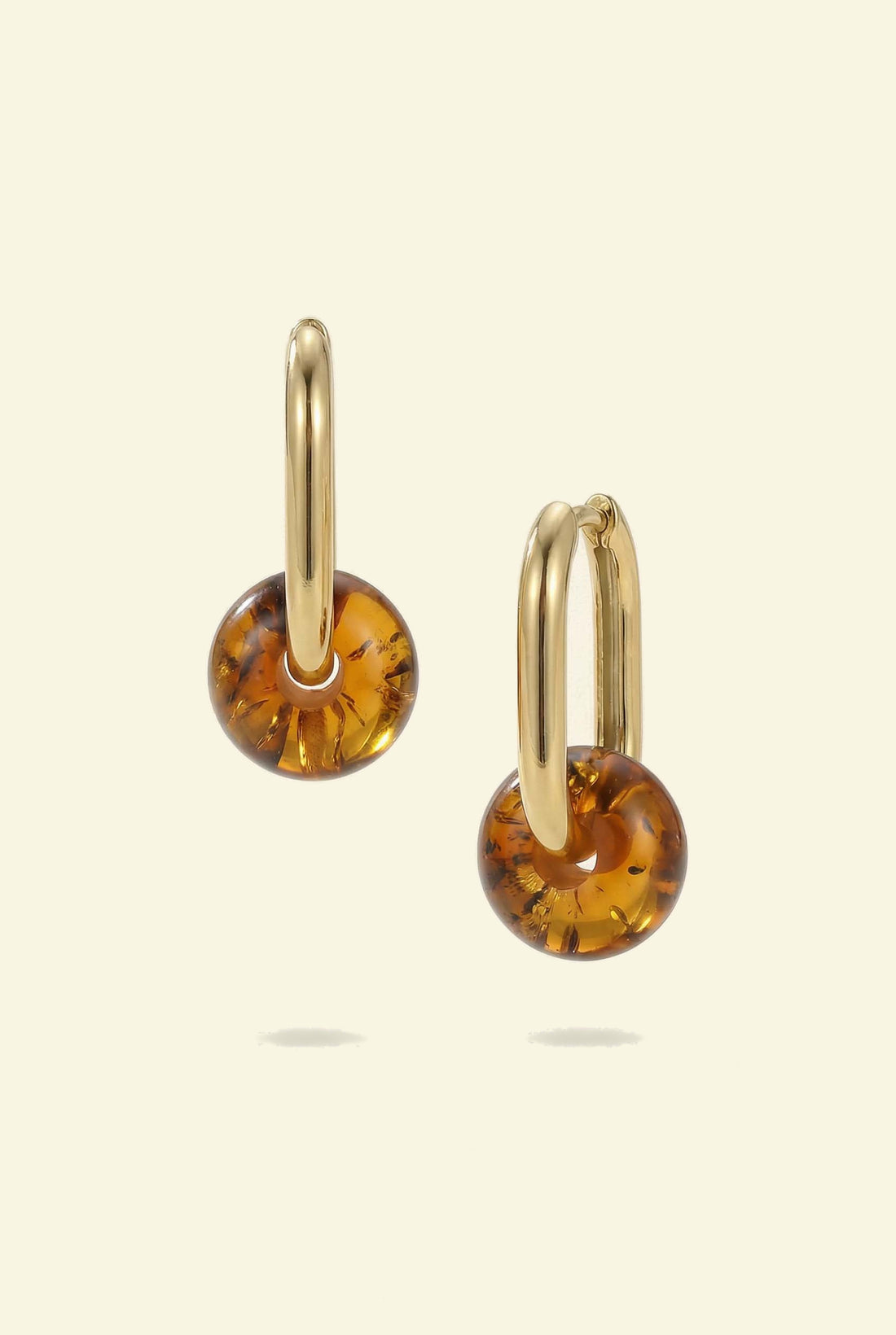Dune Amber Hoops, pair of gold-tone hoops with amber-coloured beads, one shown side-on and one at an angle