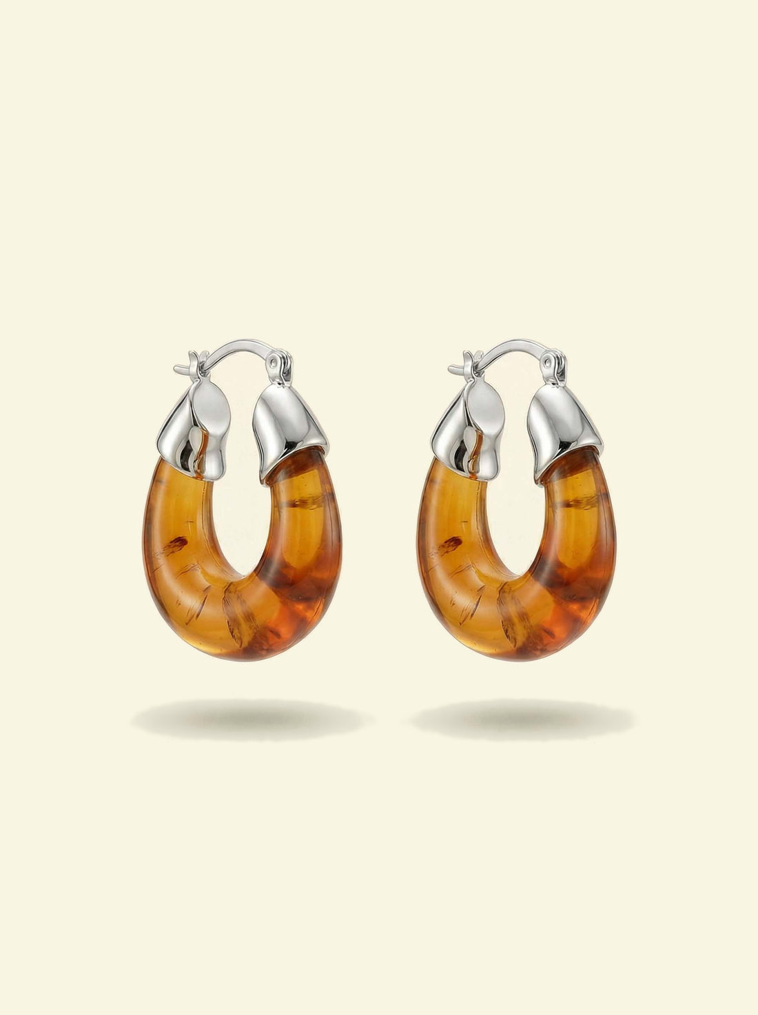 Ember Hoops, pair of translucent amber-coloured hoops with silver-tone caps, front view