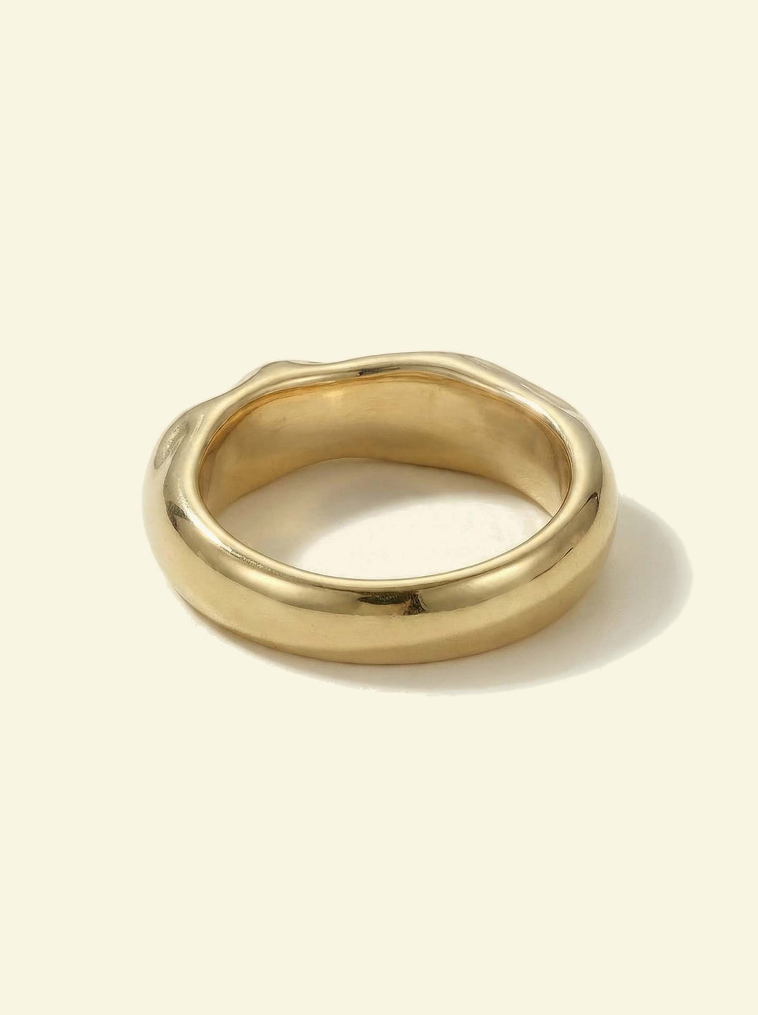 Anvil Ring, gold-tone band seen from the back, showing the smooth rounded outer edge and inside