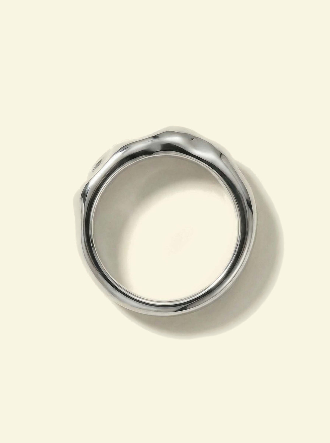 Anvil Ring, silver-tone band seen from above, showing the round opening and uneven surface