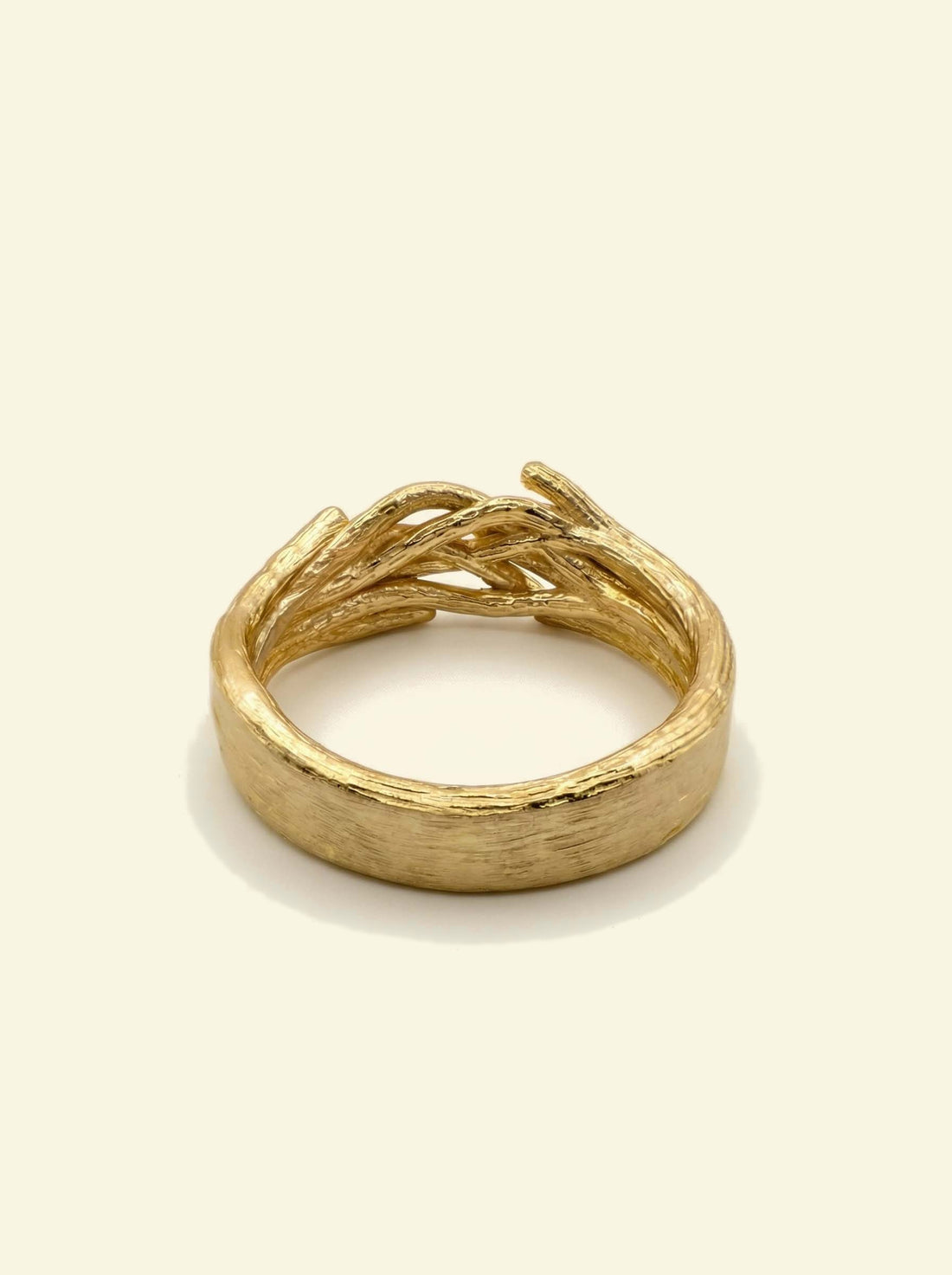 Oak Ring, gold-tone ring viewed from the side, brushed band with woven branches on top