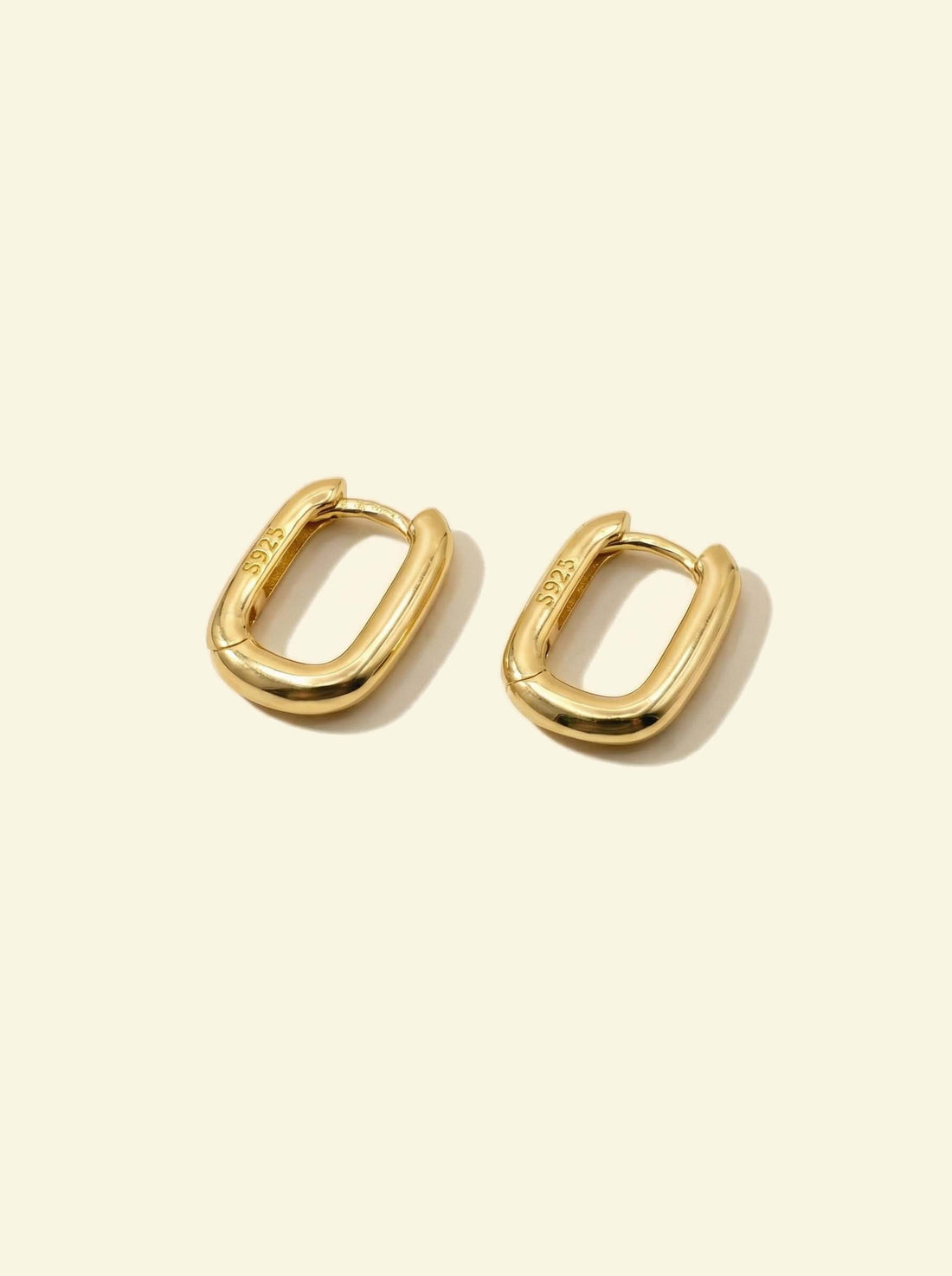 Link Mini Ovals, pair of small gold-tone oval hoops lying at an angle, S925 stamp visible