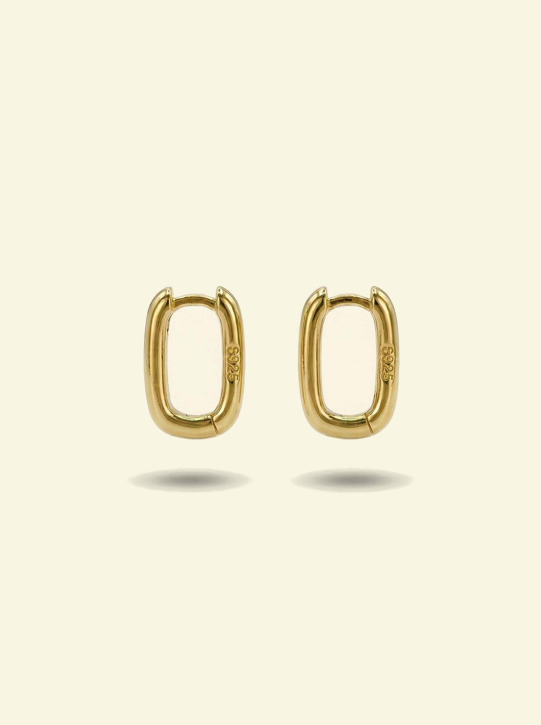 Link Mini Ovals, pair of small gold-tone oval hoop earrings, closer front view with shadows below