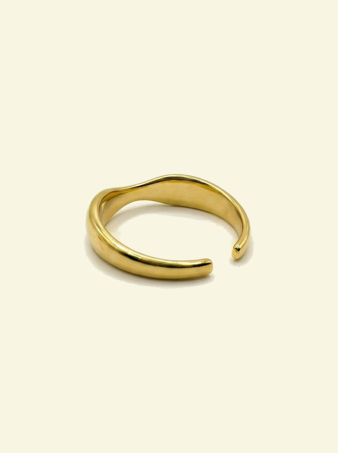 River Ring, gold-tone open band seen from behind, showing the inside of the wave