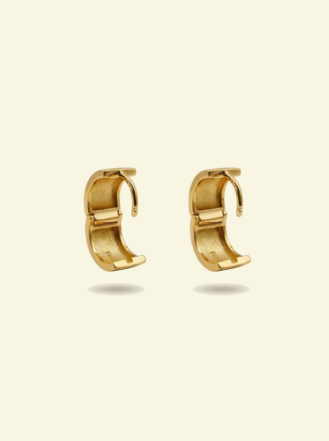 Forge Hoops, pair of gold-tone hoops opened to show the hinged clasp and inner surface