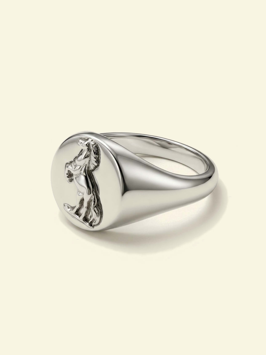 Stallion Signet, silver-tone oval signet ring with a rearing horse in relief, three-quarter view