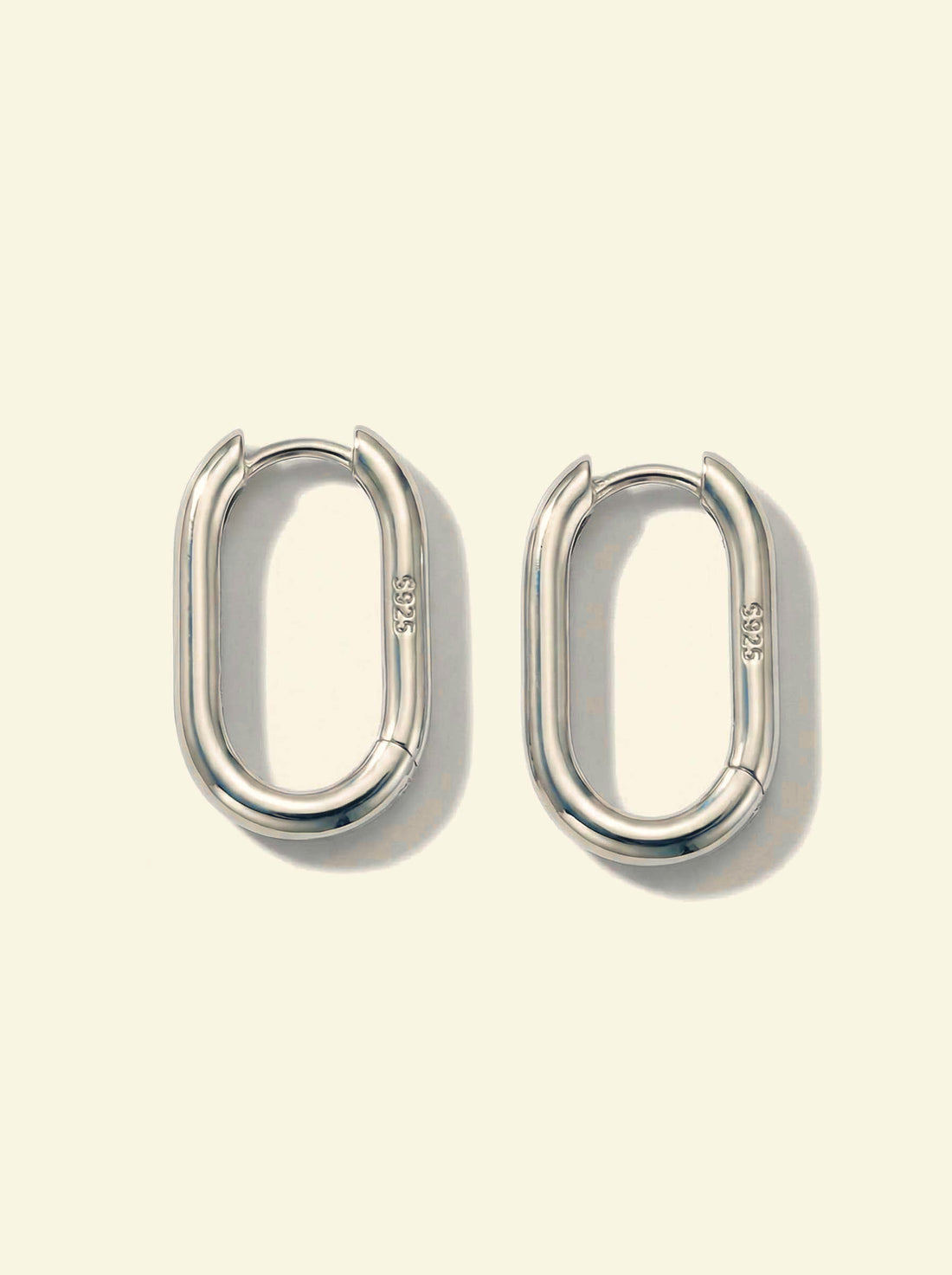 Link Large Ovals, pair of silver-tone oval hoop earrings with S925 stamp, close slightly angled view