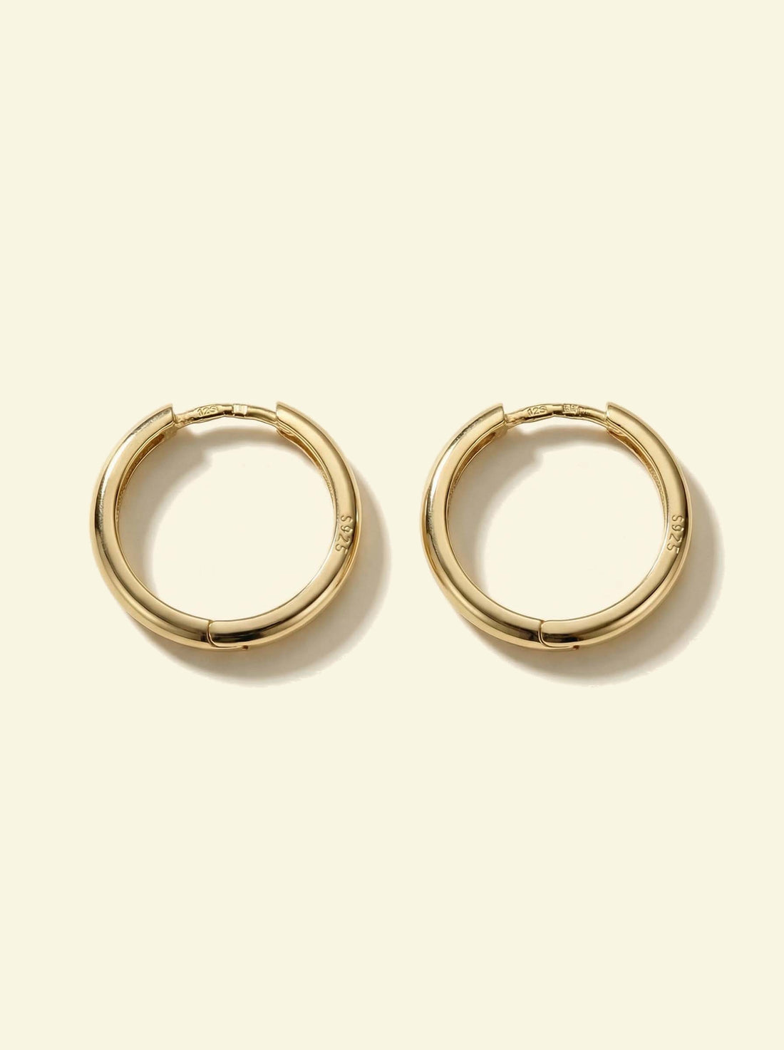 Classic Hoops, pair of smooth gold-tone hoops lying flat, face-on with S925 stamp visible