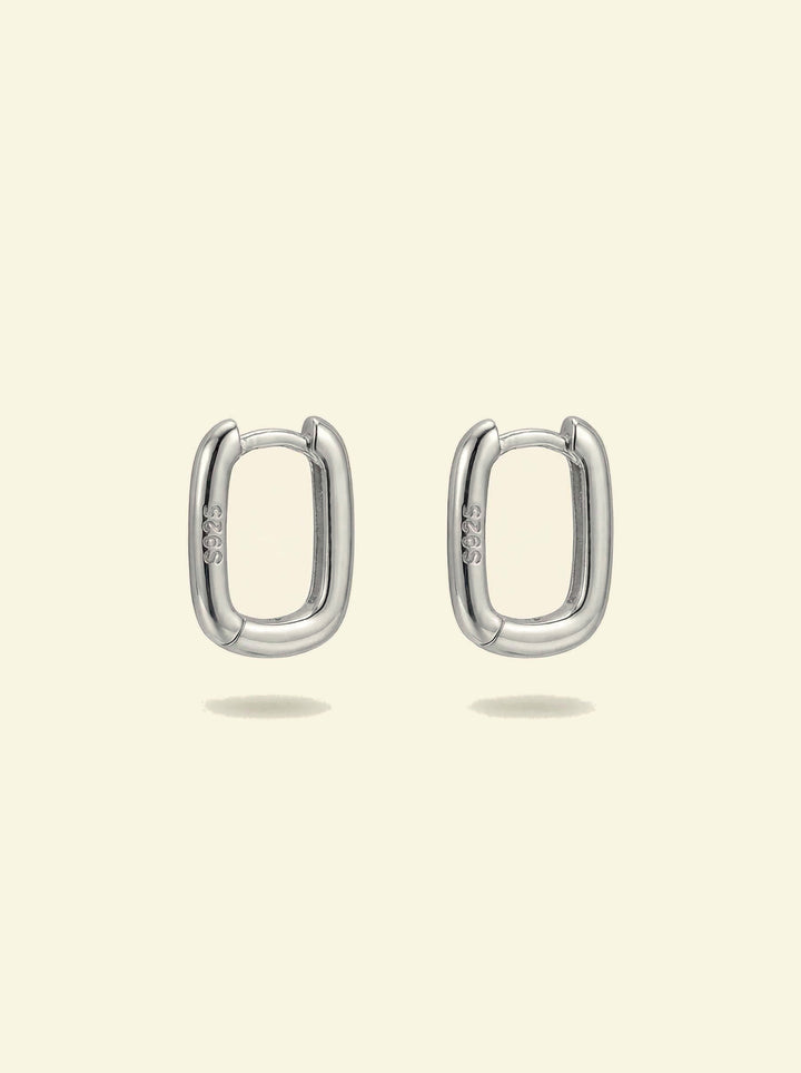 Link Mini Ovals, pair of small silver-tone oval hoop earrings with S925 stamp, front view