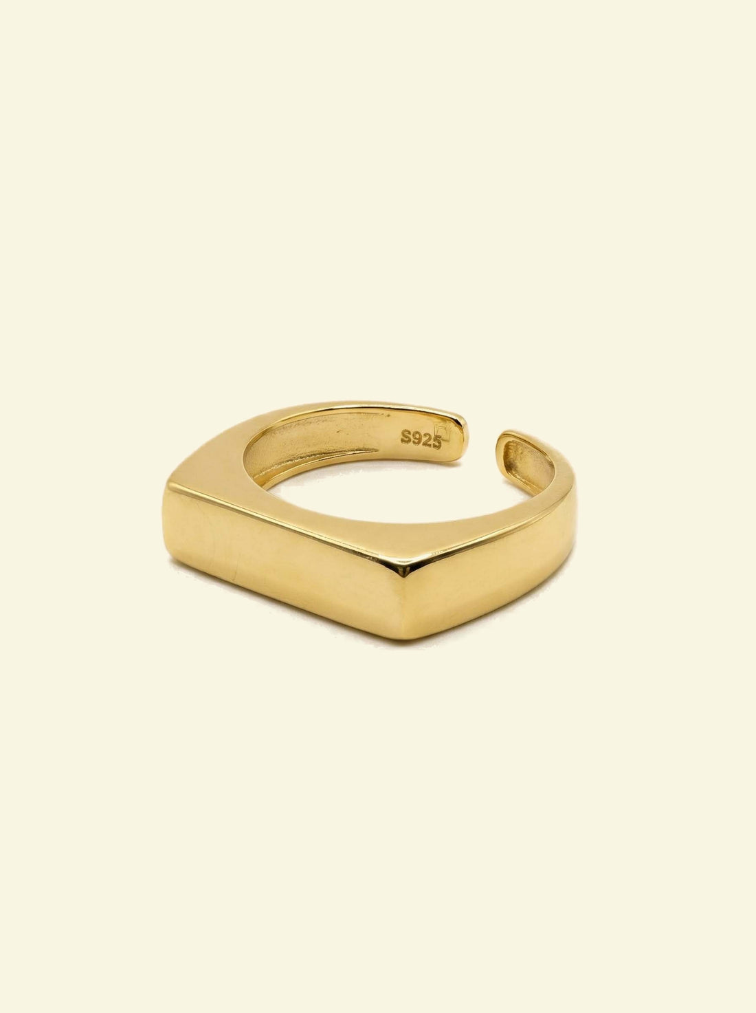 Preila Ring, gold-tone open band with a flat rectangular top, three-quarter view with S925 stamp inside