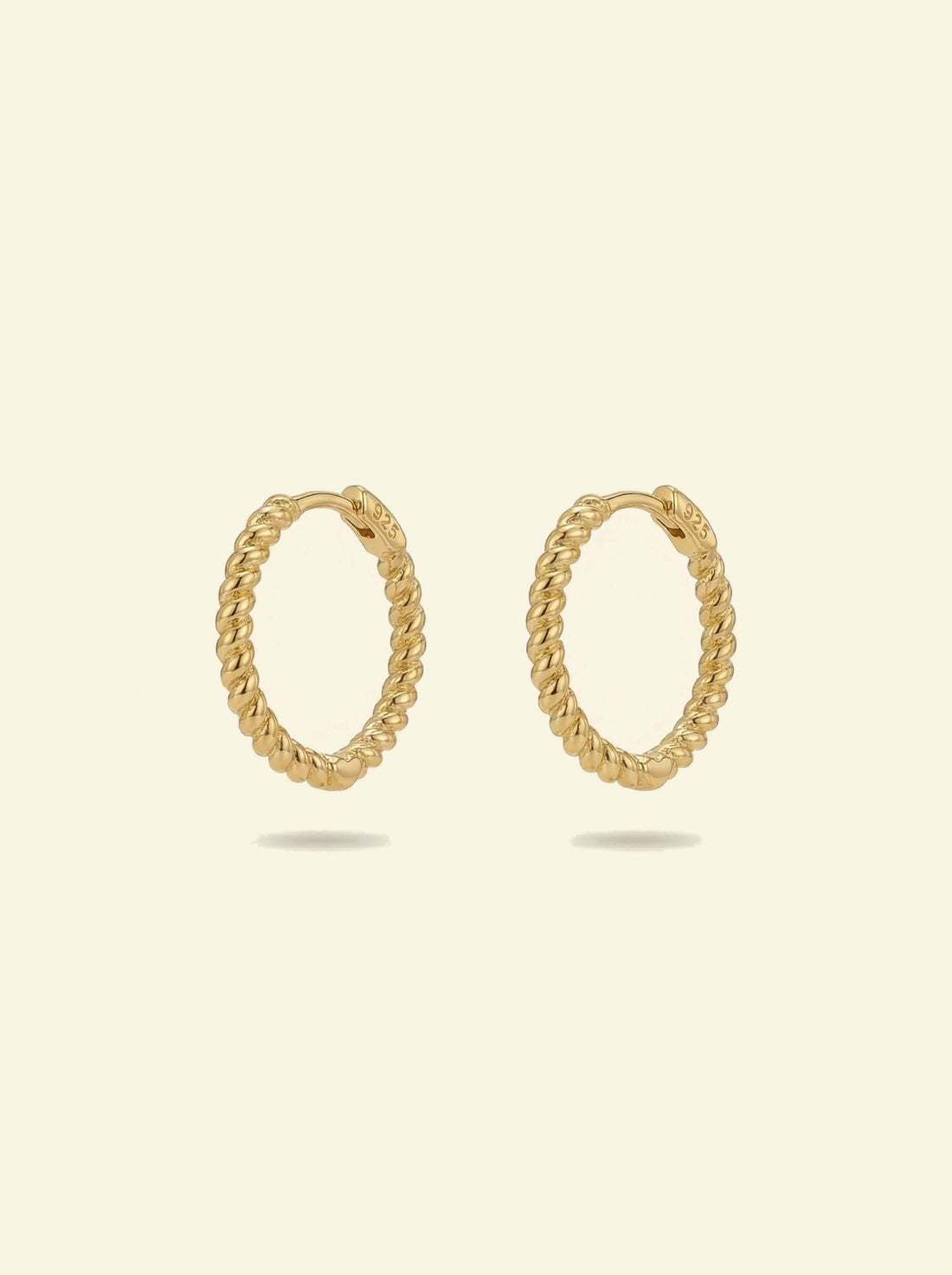 Sol Hoops, pair of gold-tone twisted rope hoops standing upright, front 3/4 view