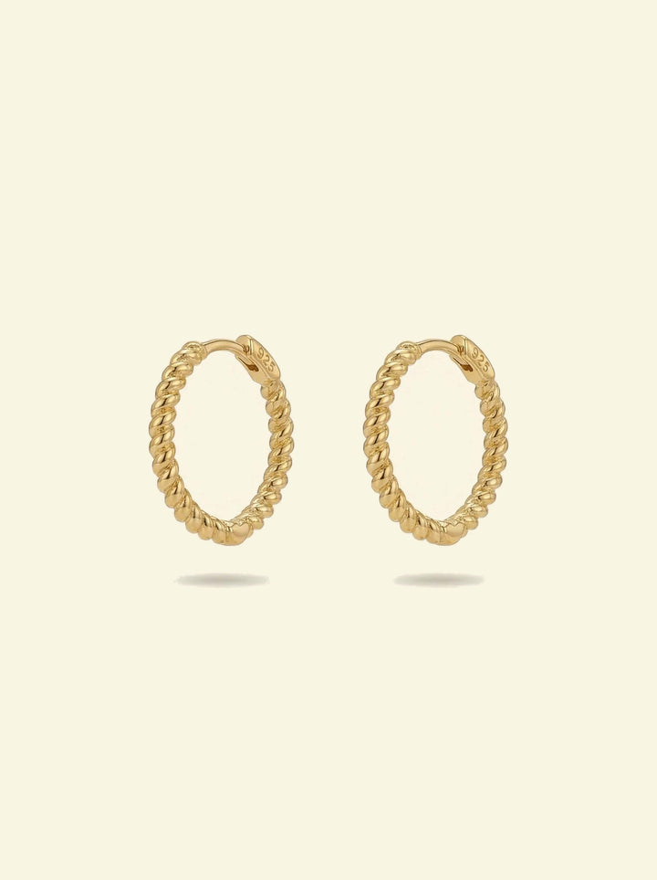 Sol Hoops, pair of gold-tone twisted rope hoops standing upright, front 3/4 view