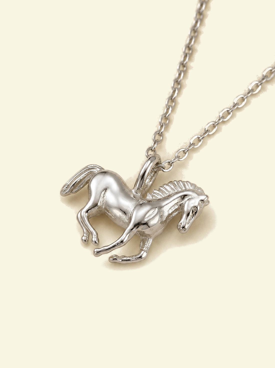 Stallion Pendant, close-up of the silver-tone horse pendant at an angle showing the mane, bail and chain