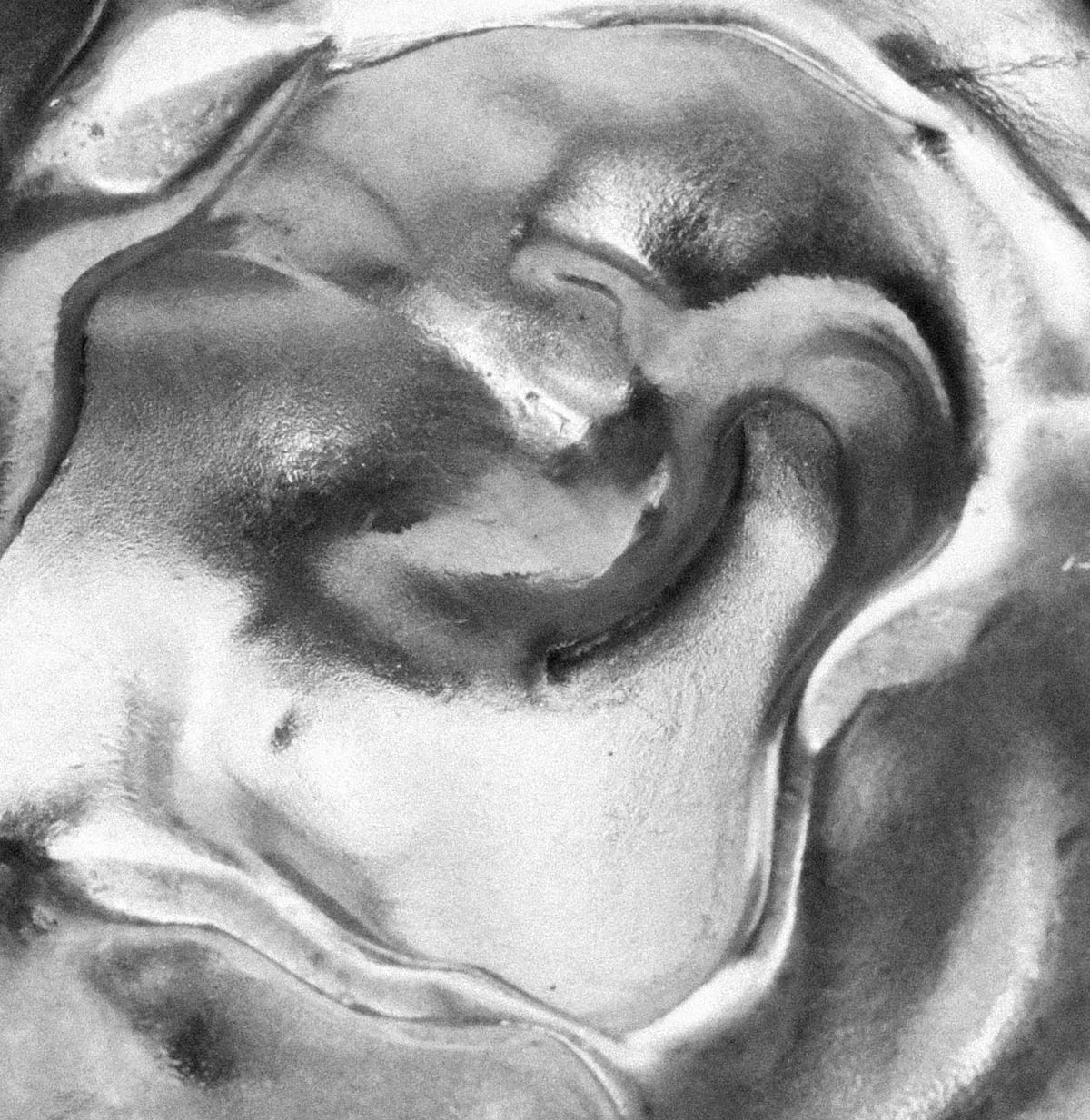 Abstract black and white swirls of polished molten silver