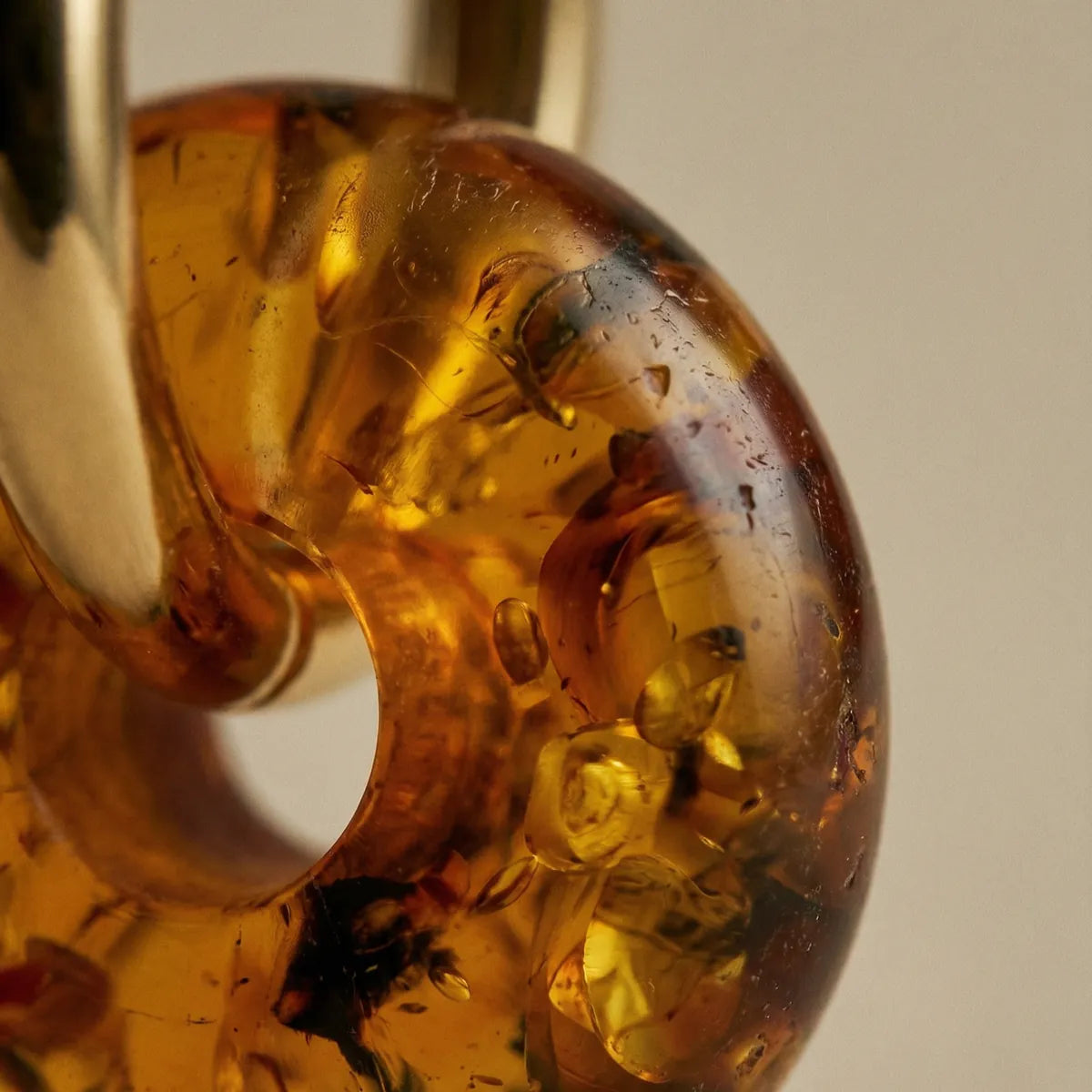 Close-up of a polished honey-coloured Baltic amber piece with natural inclusions