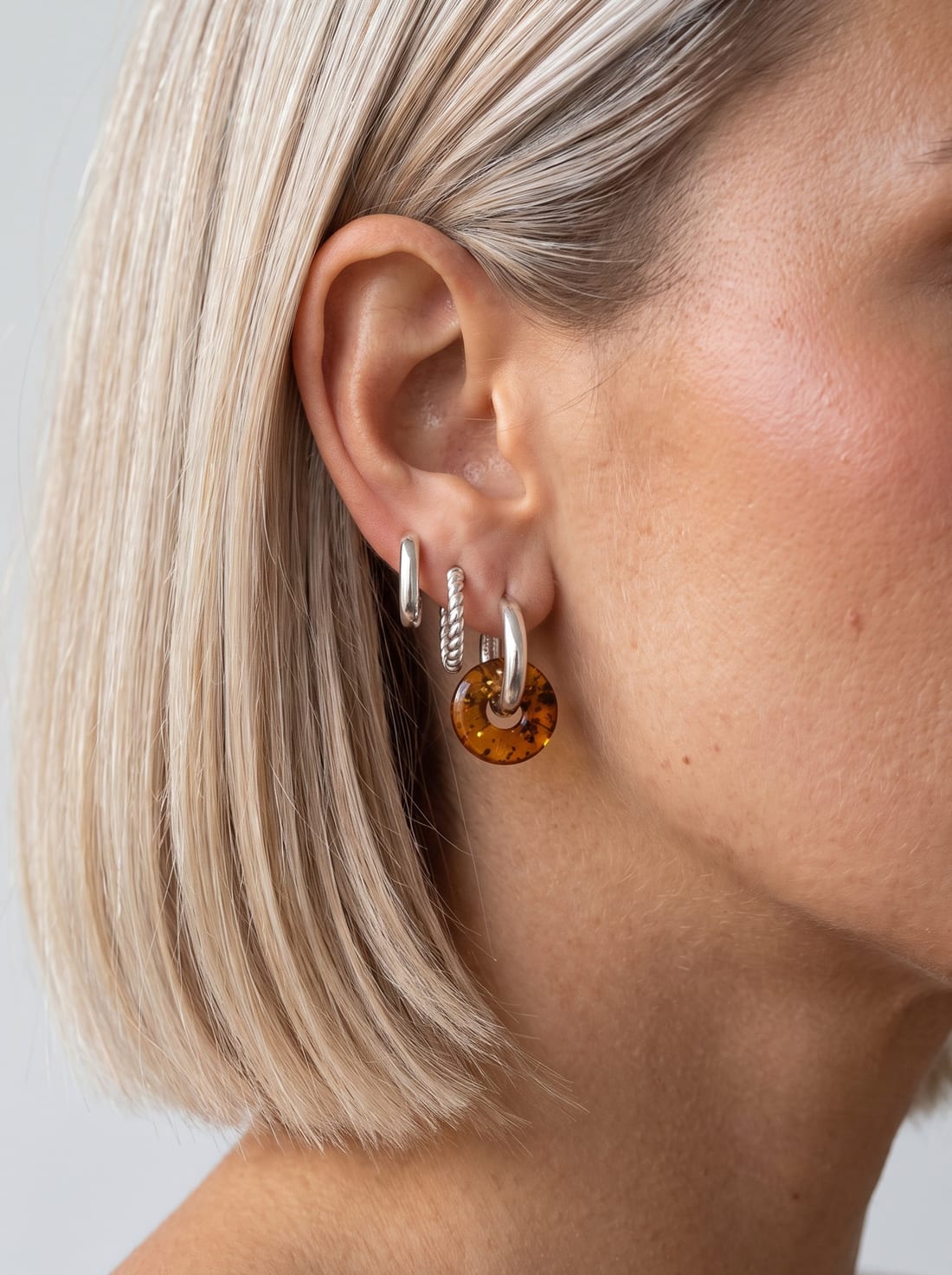 Look styled with Nida Amber Hoops, Link Mini Ovals and Sol Hoops (Silver)